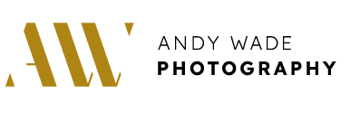 A logo with golden stylized initials "AW" on the left and "Andy Wade Photography" in black text on the right. The "AW" appears large and angled with creative gaps. The words "Andy Wade" are above "Photography" with "Photography" in bold. The background is white. - Image by Andy Wade Photography