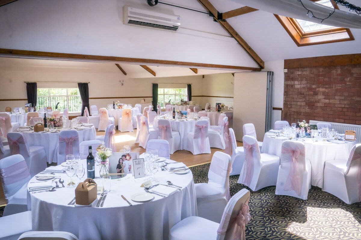 A room with tables and chairs at the Stables Country Club in Lancashire. Image by Andy Wade Photography.