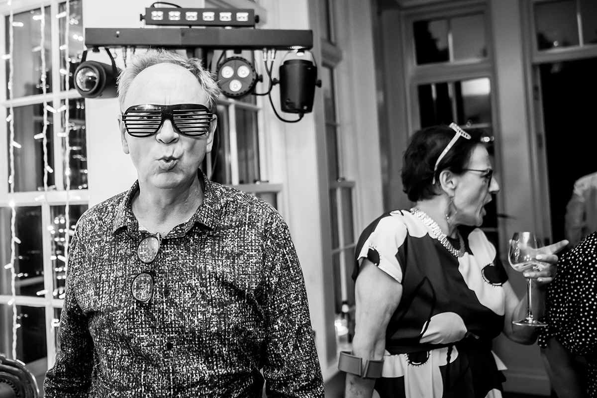 Man wearing sunglasses at lively party