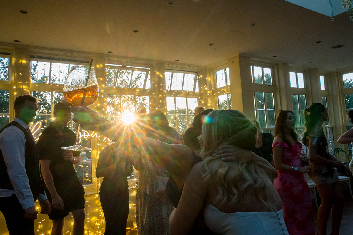People celebrating at a party with fairy lights.