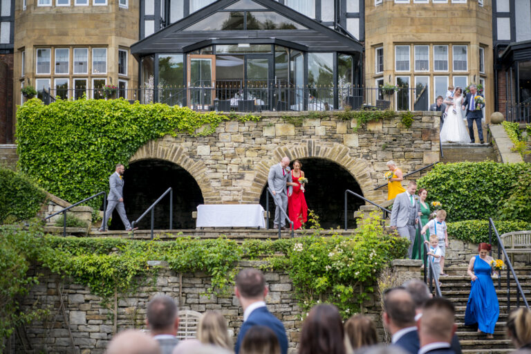 Wedding guests descending stone steps outside venue