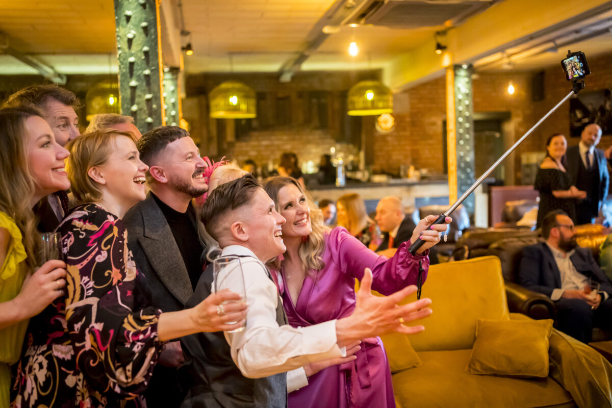 Group of people taking a selfie at party.