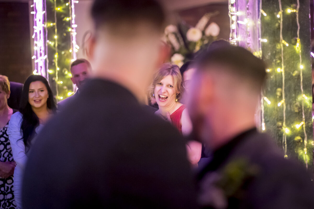 People laughing and smiling with festive lights.
