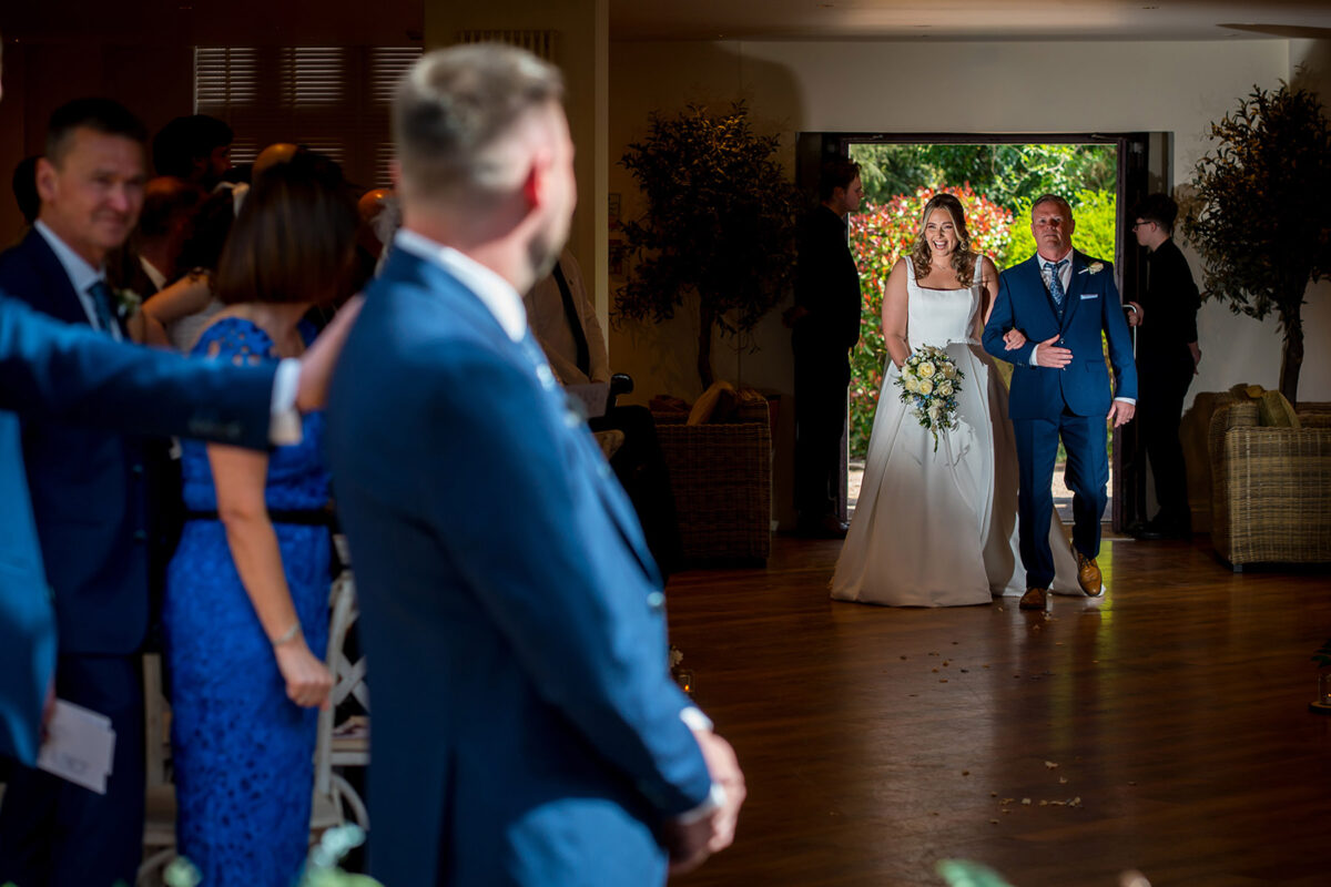 Bride walking down the aisle with father.