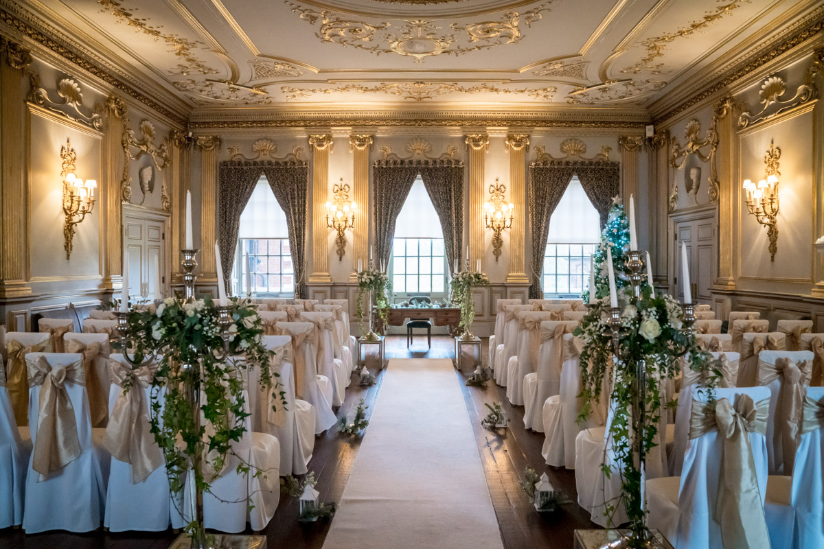 Opulent ballroom set up for a wedding ceremony.