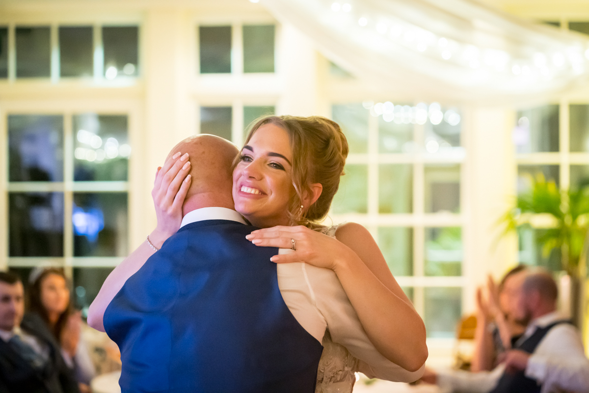Happy couple dancing at wedding reception.