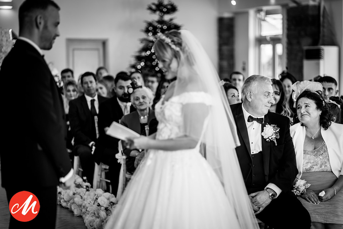 Bride reads vows during wedding ceremony.