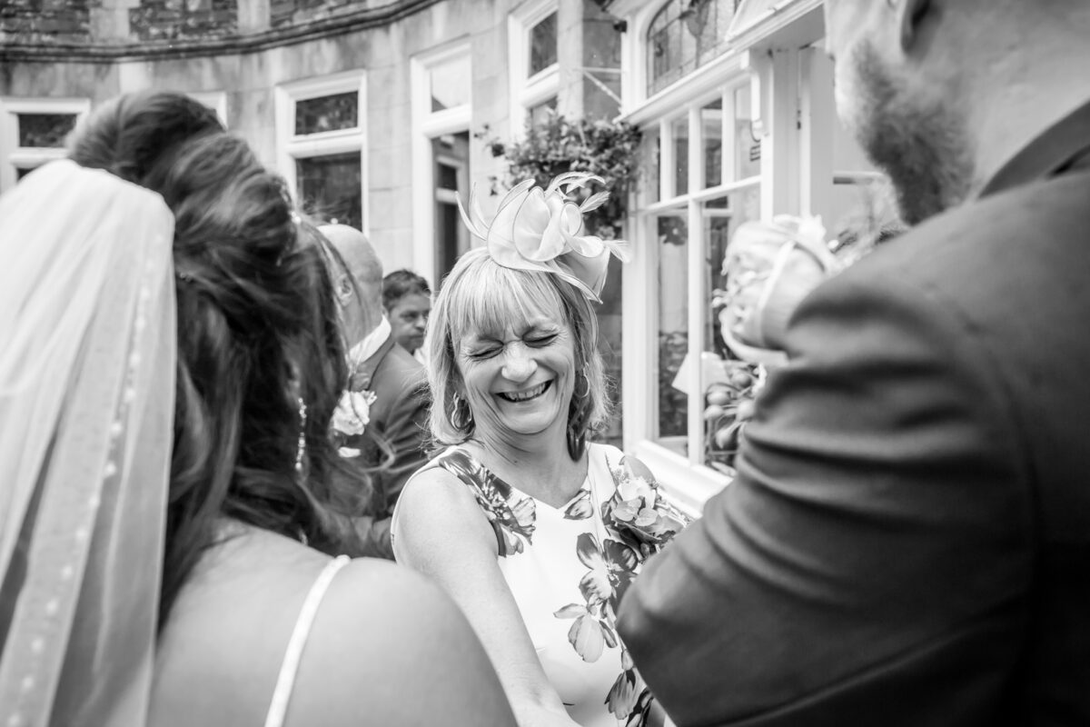 Laughing woman at a wedding celebration.