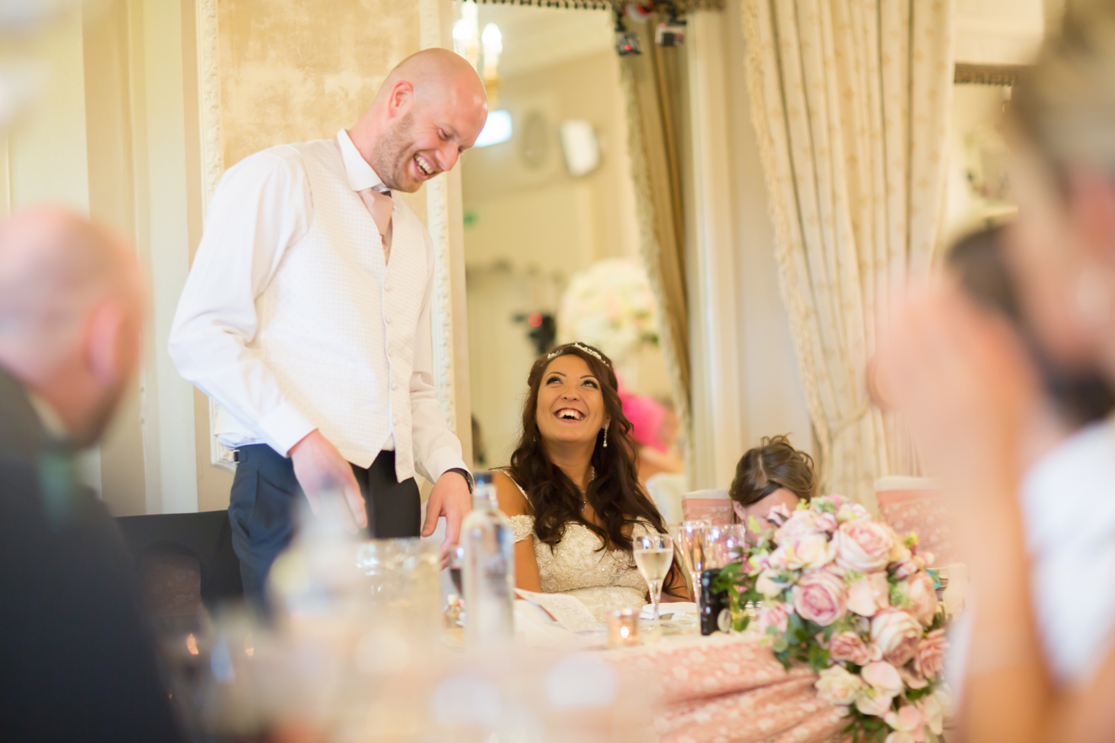 Wedding speech moment with smiling bride and groom