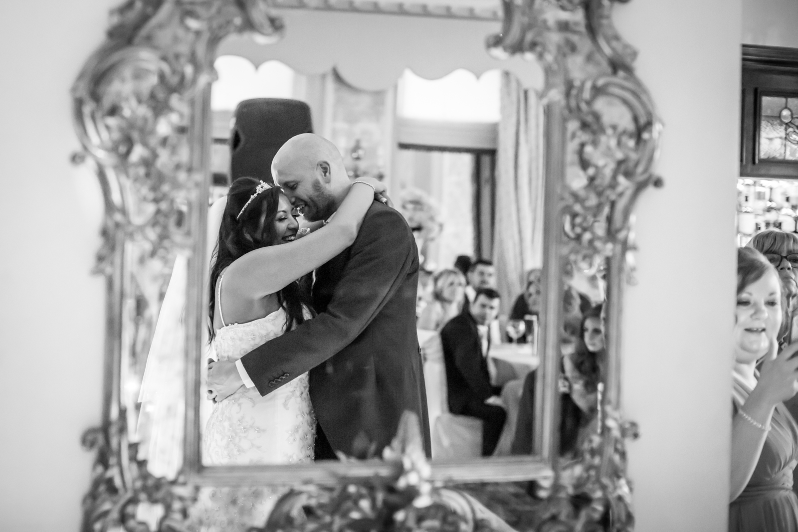 Happy couple embracing at wedding reception.