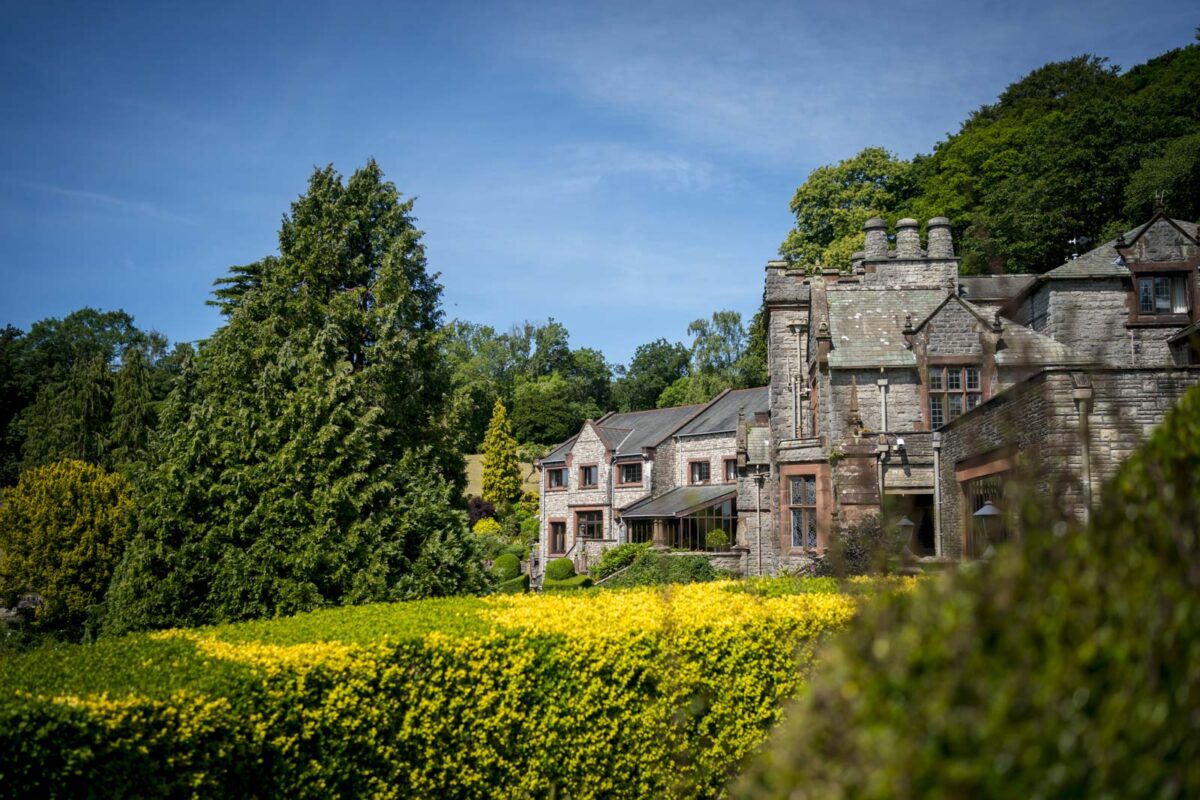 Historic manor house with lush green gardens.
