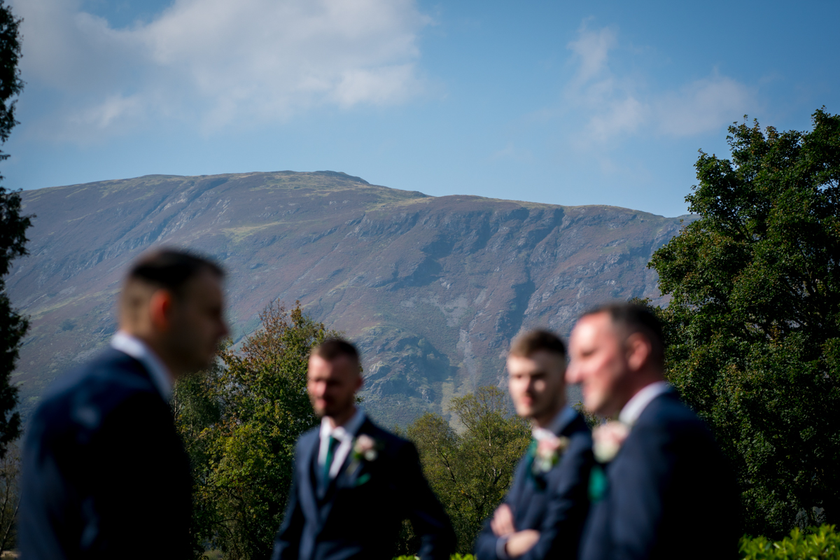 Blurred men in suits with mountain background