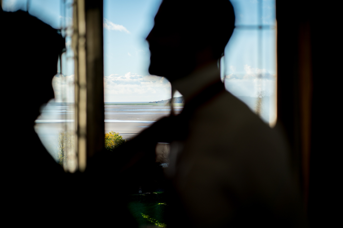 Silhouetted figures by a sunny window view.
