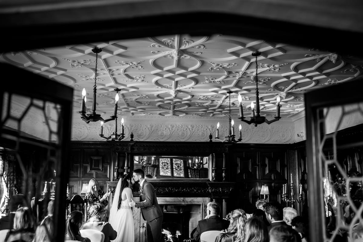 Wedding ceremony in elegant, ornate room.