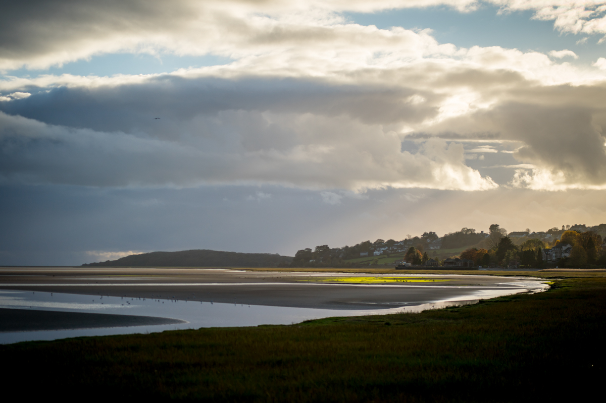 Dramatic cloudy sky over serene coastal landscape