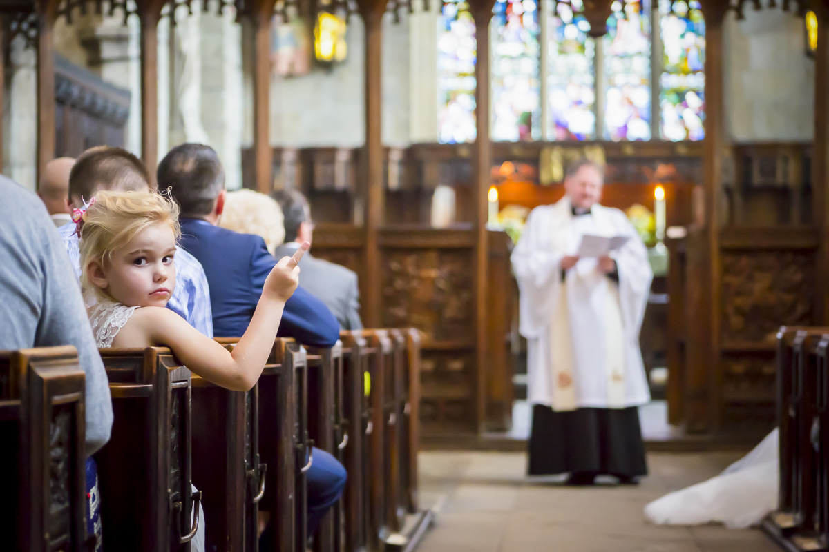 Child in church looking back at camera.