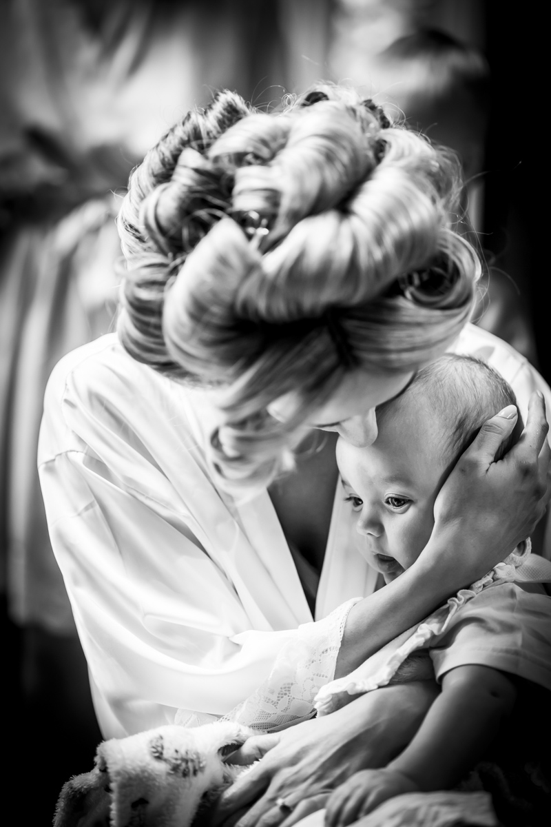 Mother cradling baby with love and care.