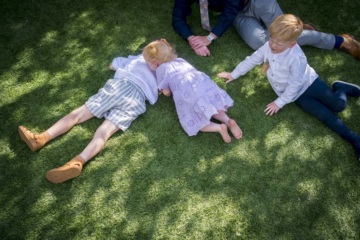 Children playing on green grass outdoors.