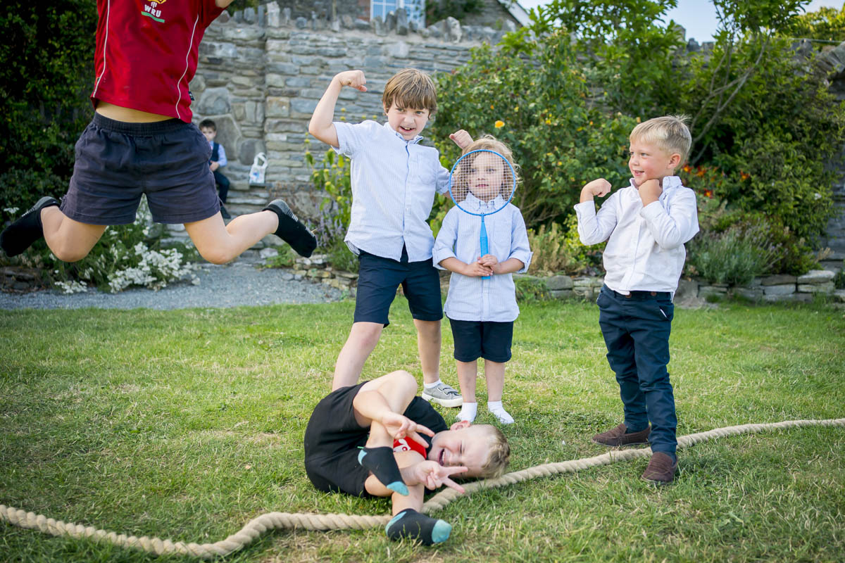 Children playing games on grass, having fun.