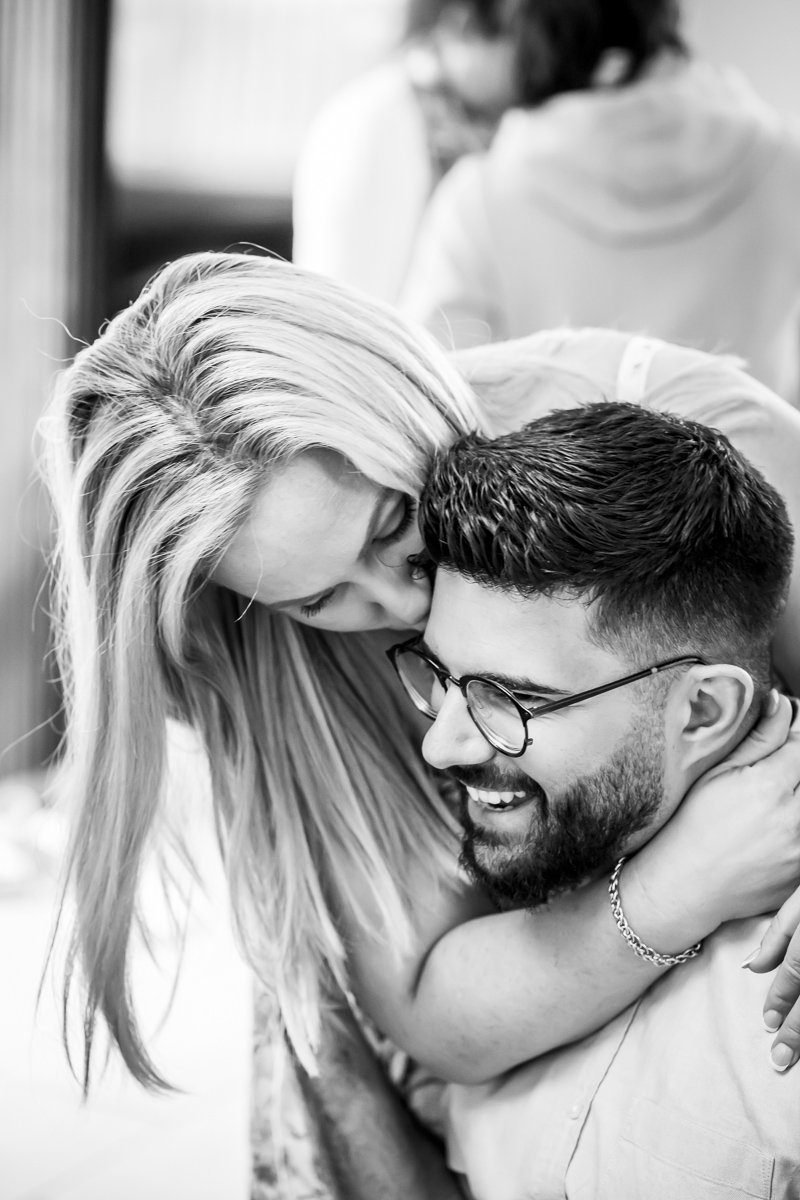 Couple embracing and smiling indoors