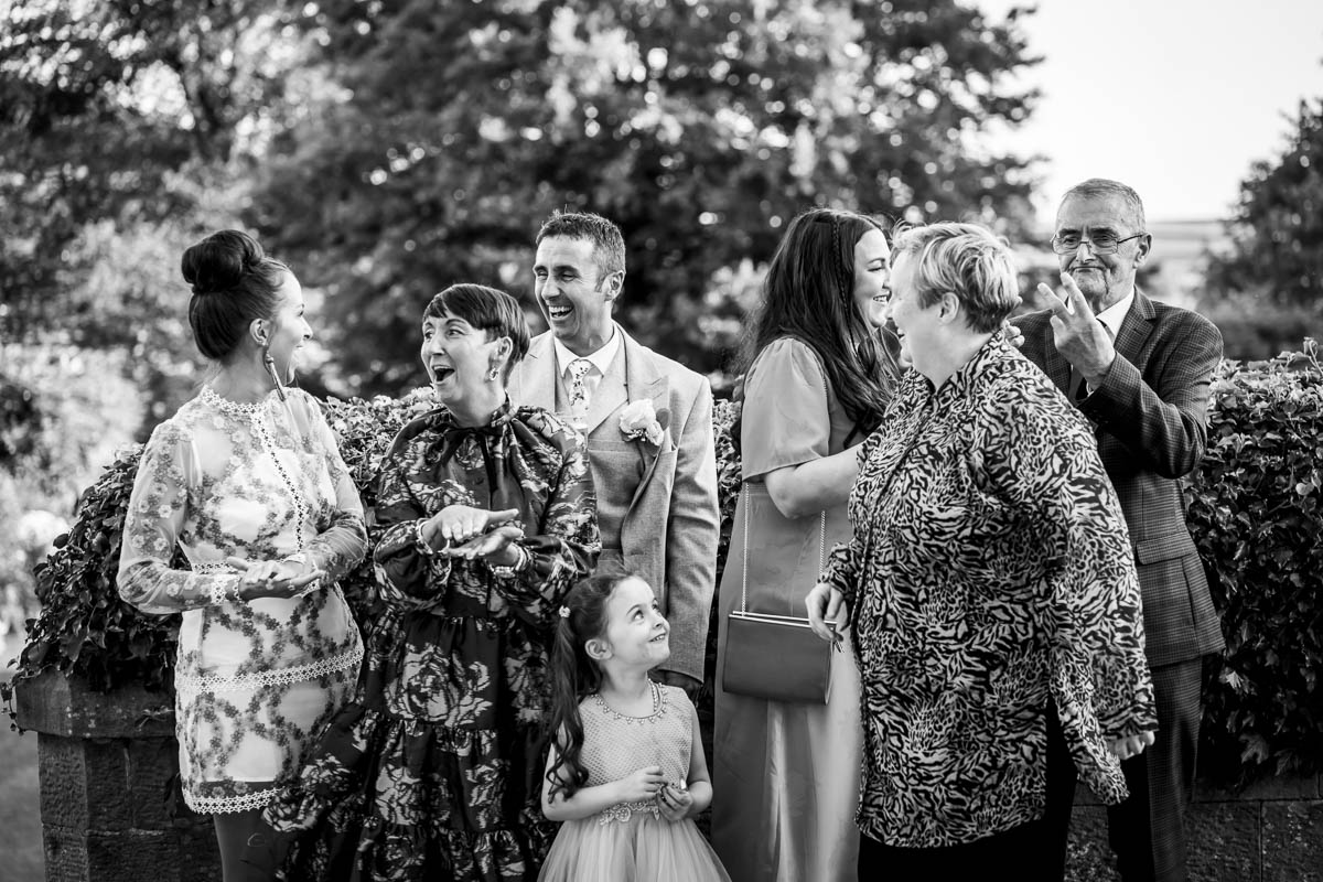 Group of people laughing outdoors at event.