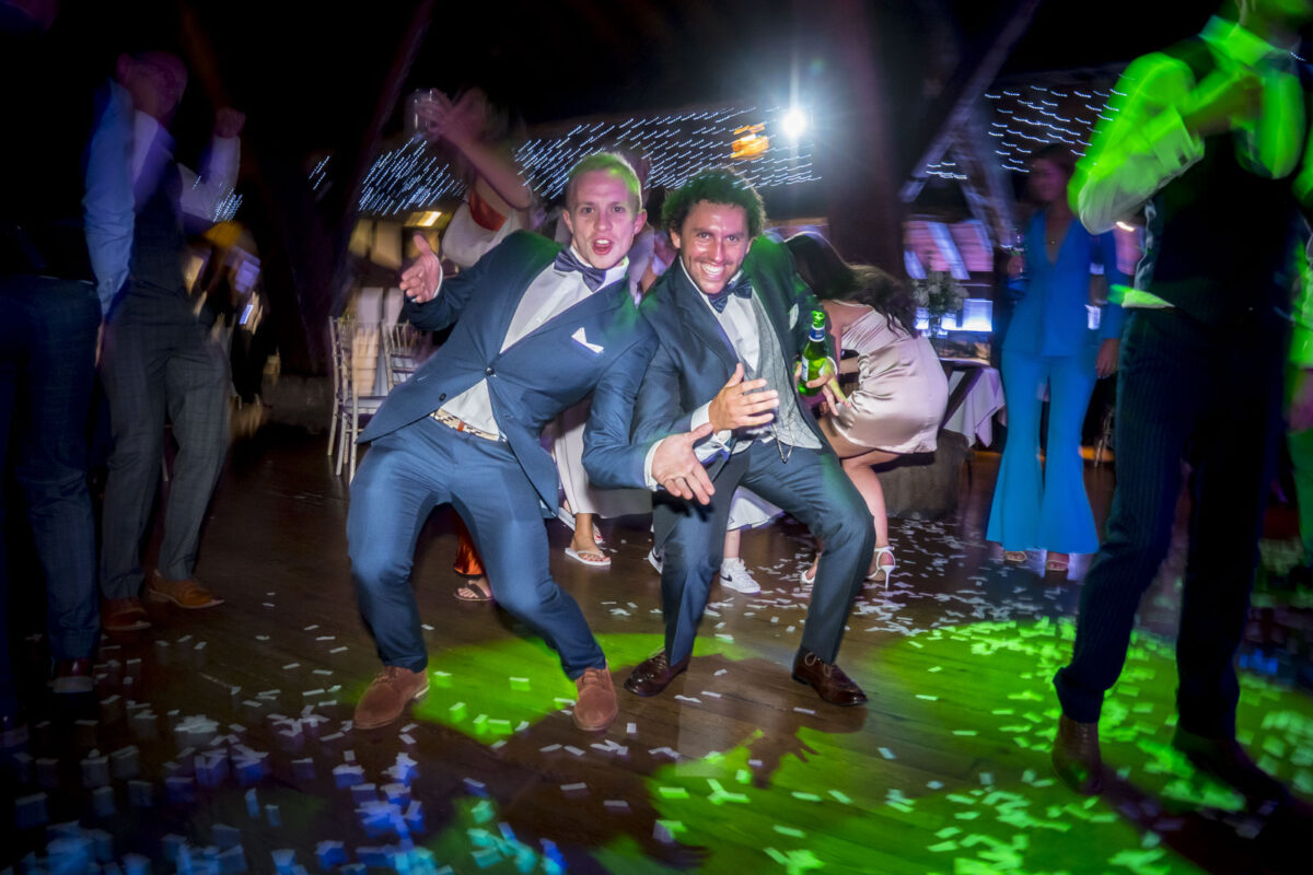 Two men dancing energetically at a party.
