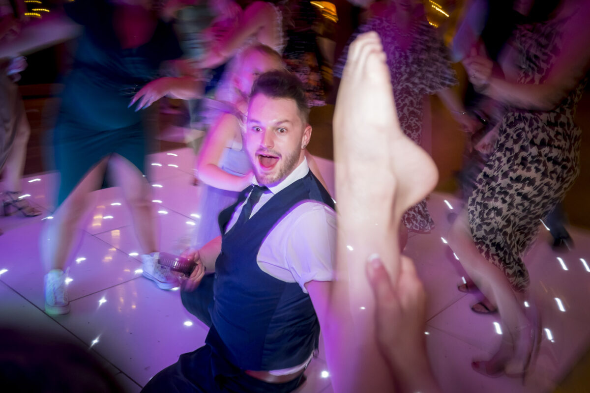 Party with excited dancers and colourful lights.