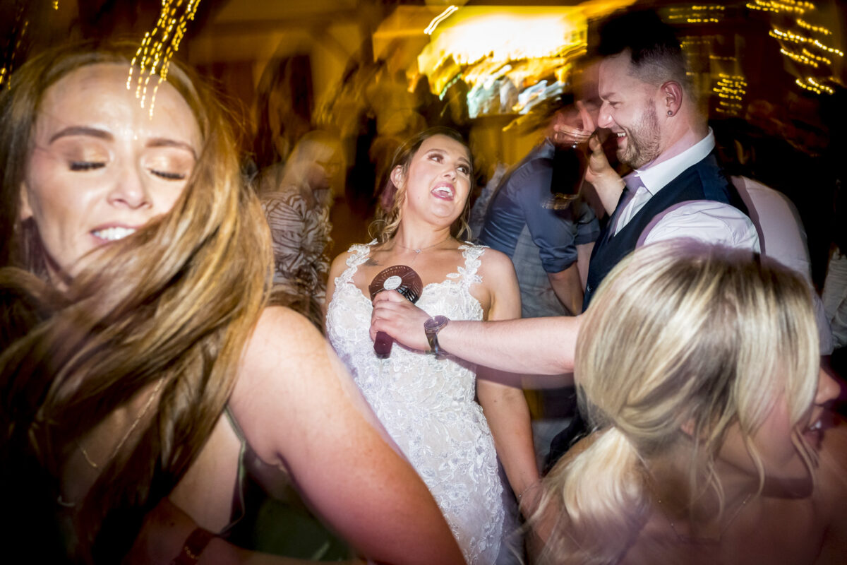 People dancing at a lively wedding reception.