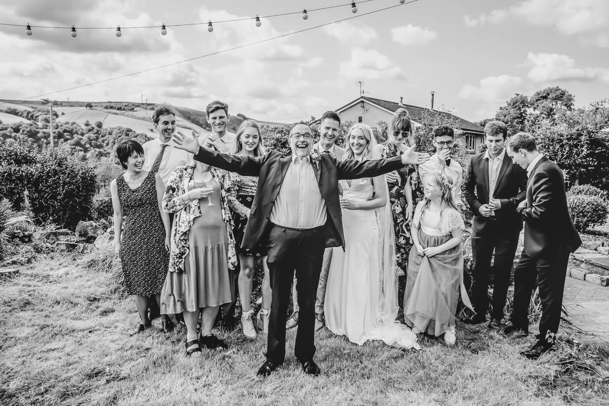 Group celebrating outdoors in formal attire.