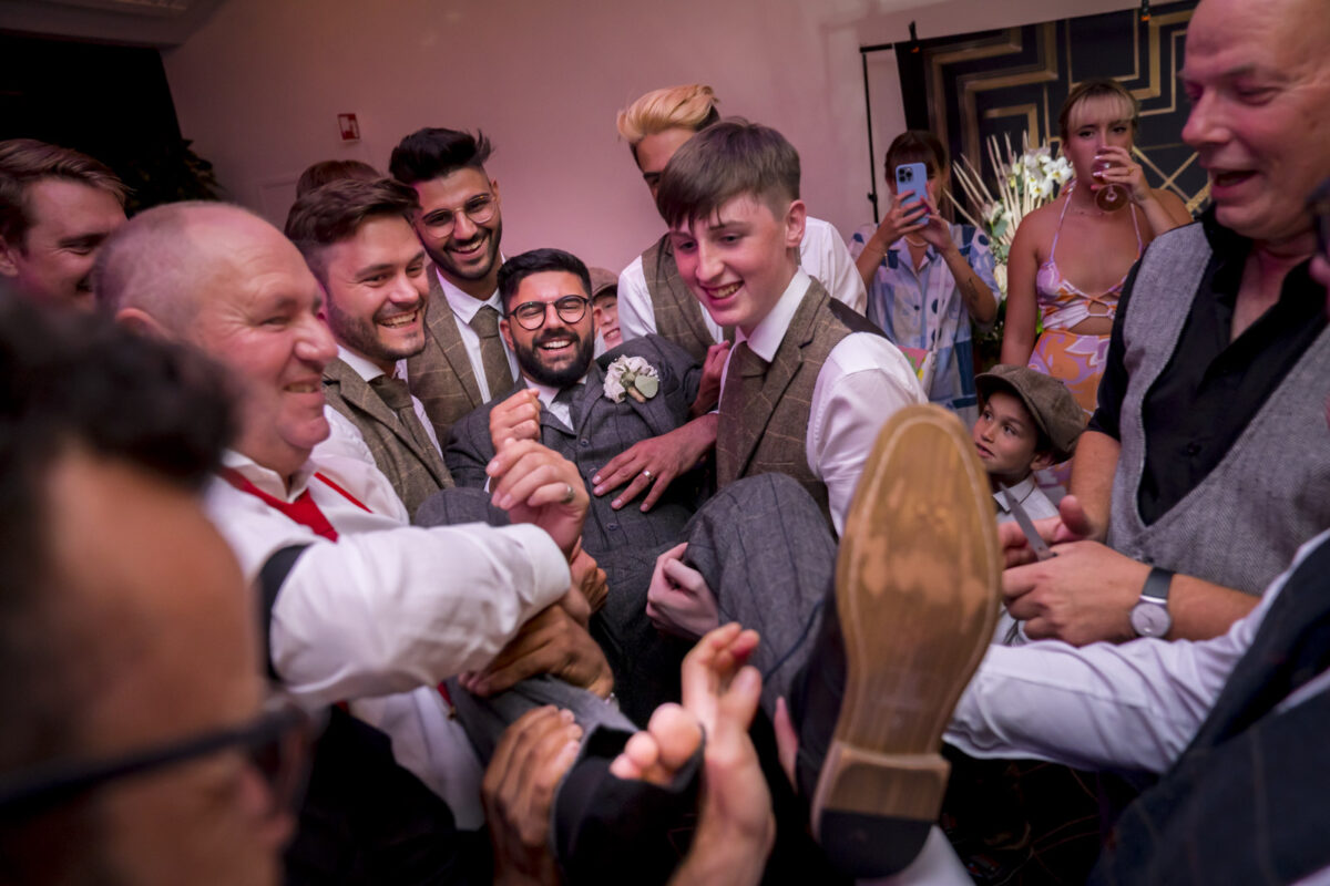 Group of joyful men at a wedding celebration.