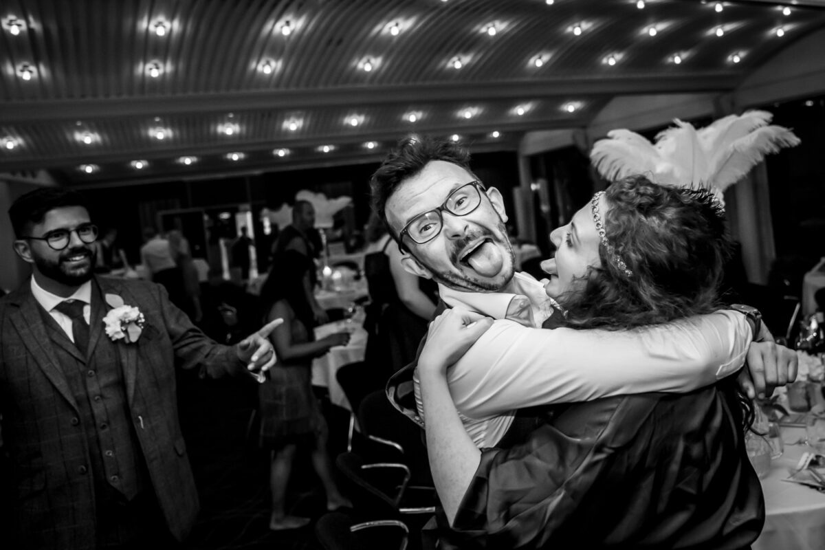 People dancing and laughing at a festive event.