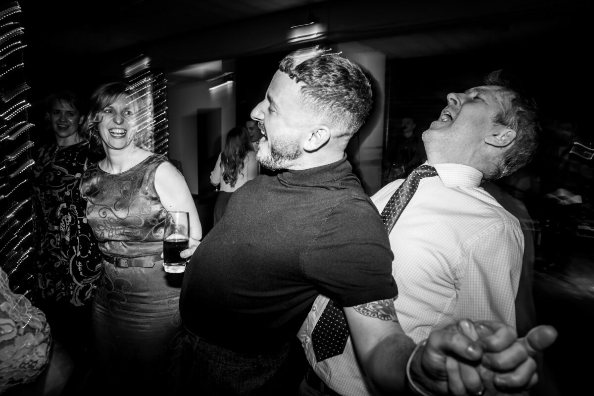 People laughing and dancing at a party.