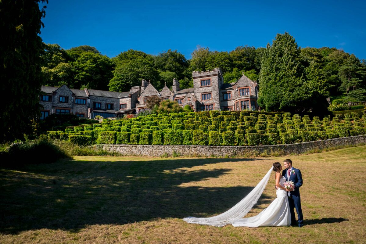 Bride and groom in front of manor house
