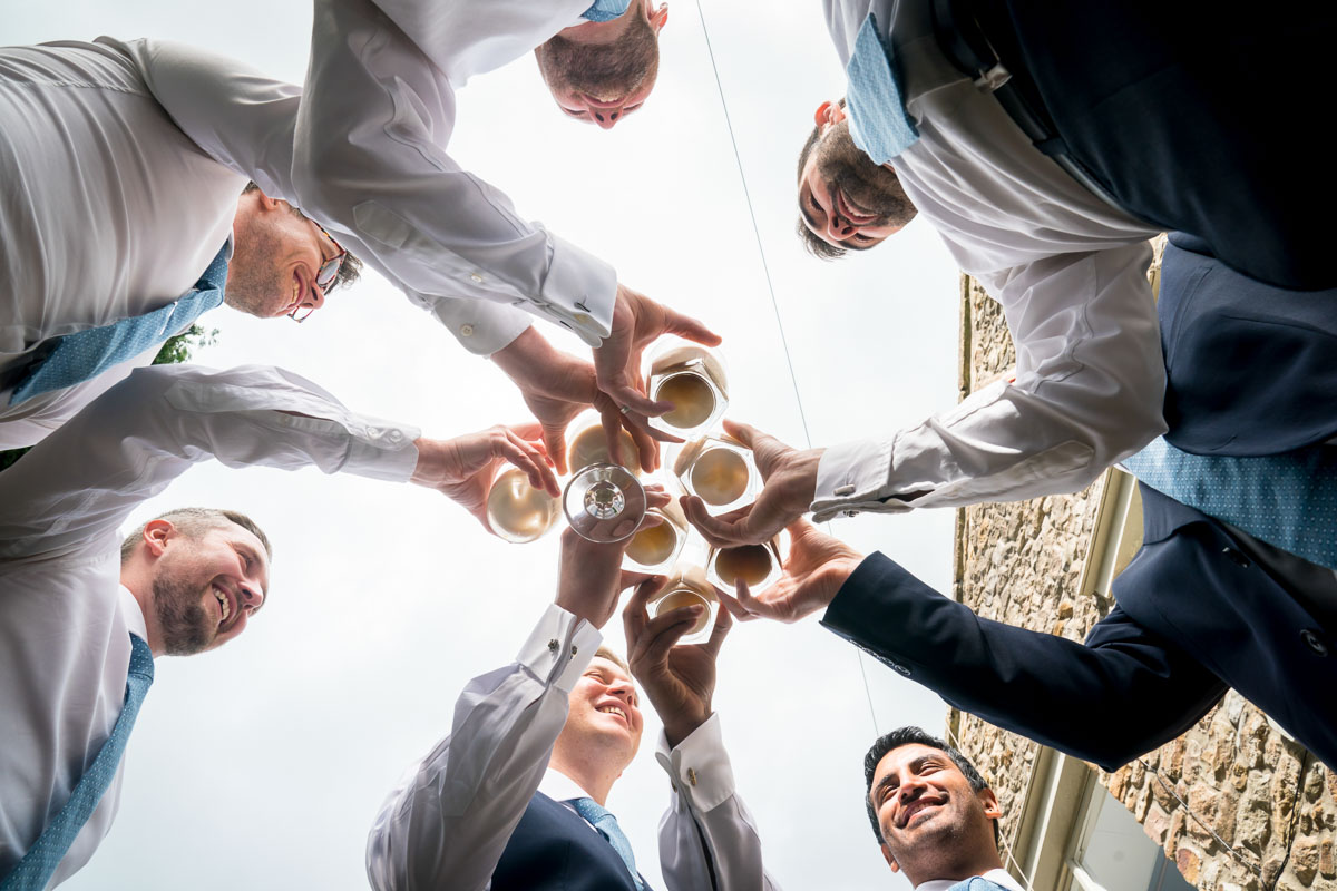 Men toasting with drinks outdoors