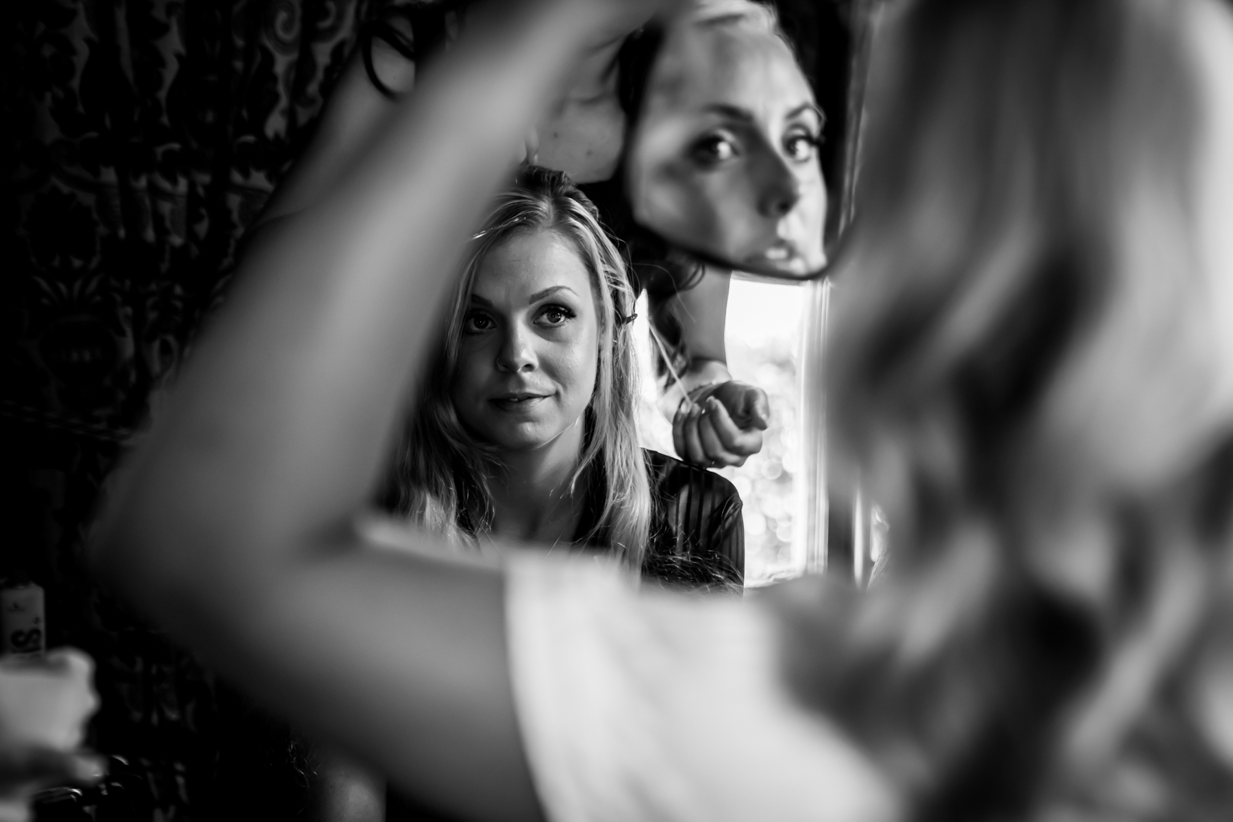 Woman's reflection in mirror during styling session