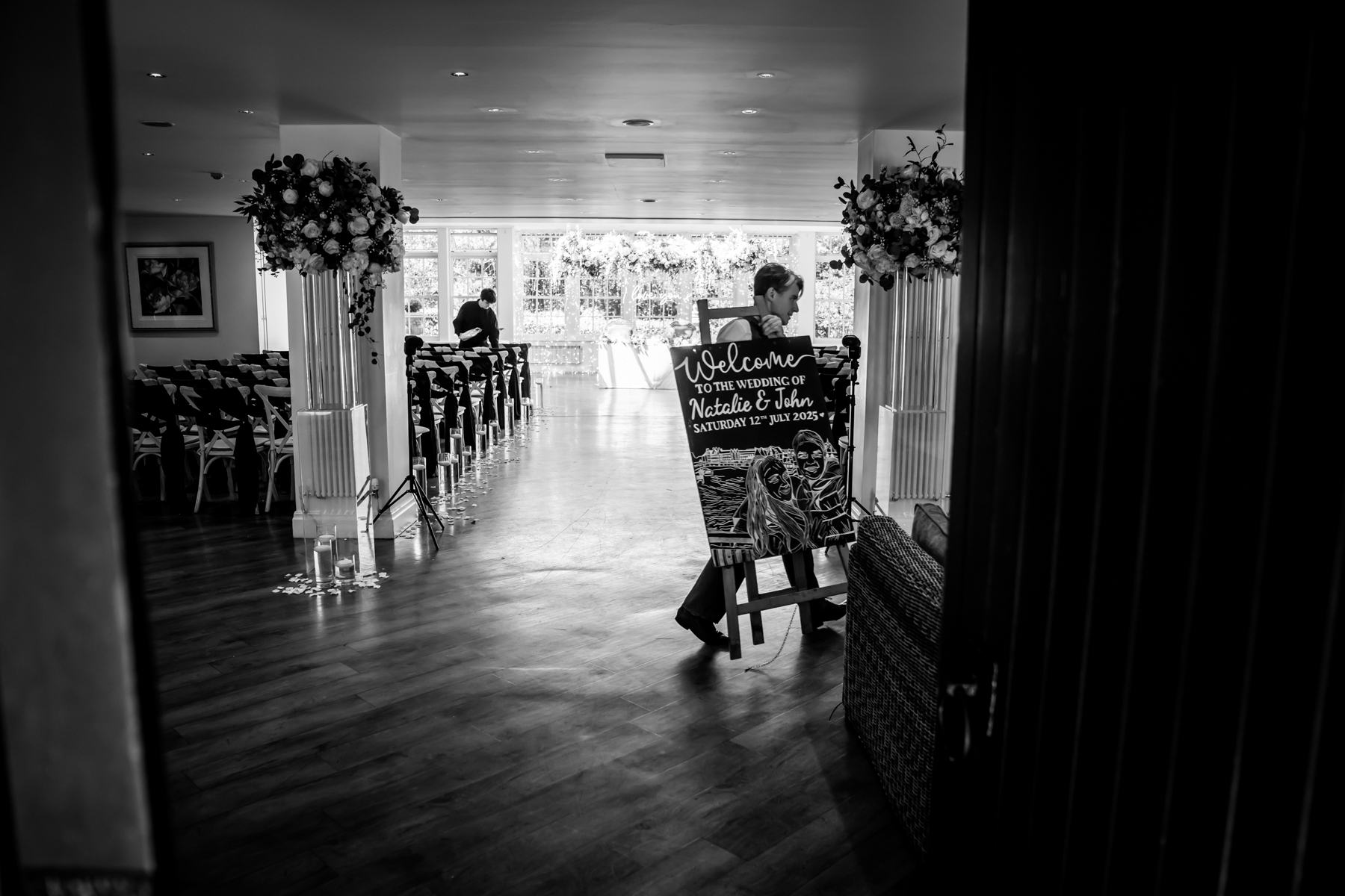 Wedding venue with welcome sign and chairs.