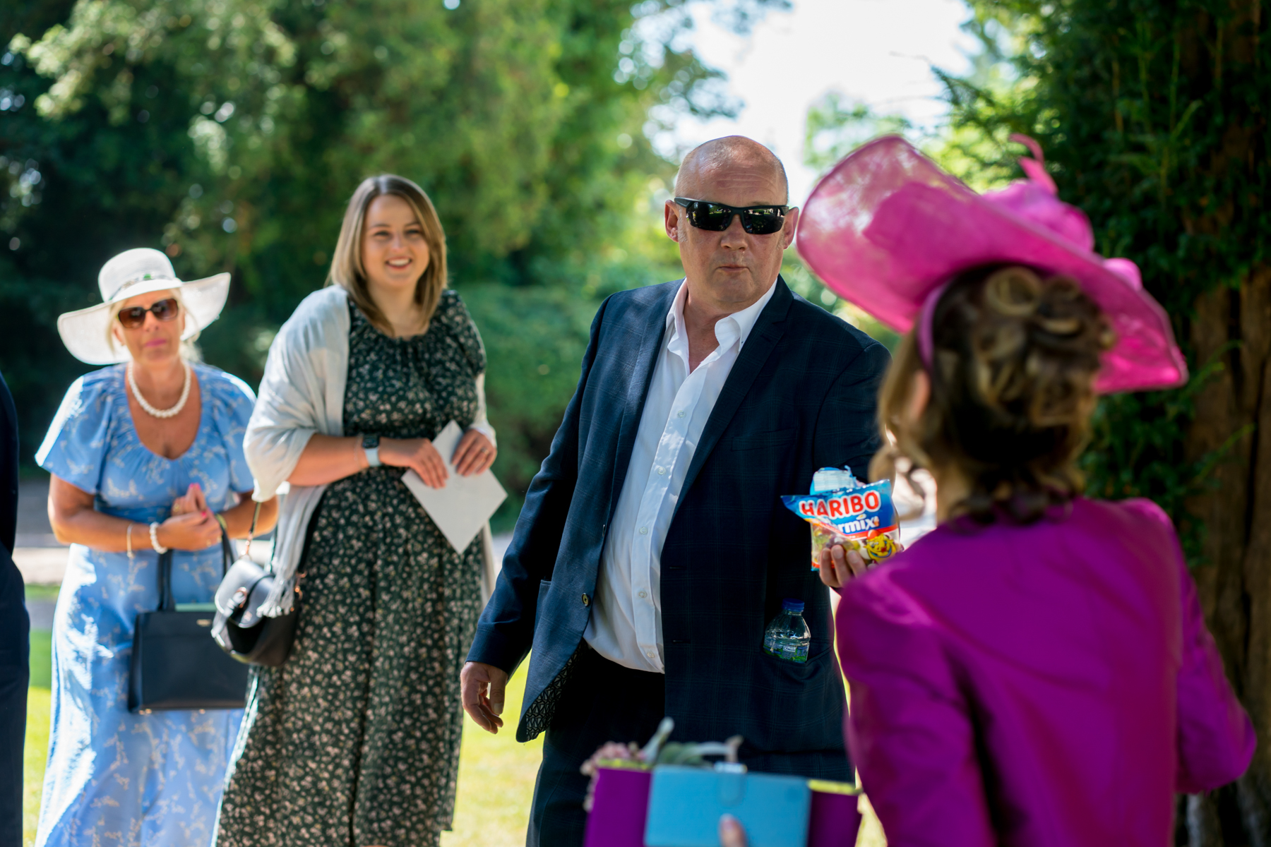 Man offers sweets at outdoor gathering