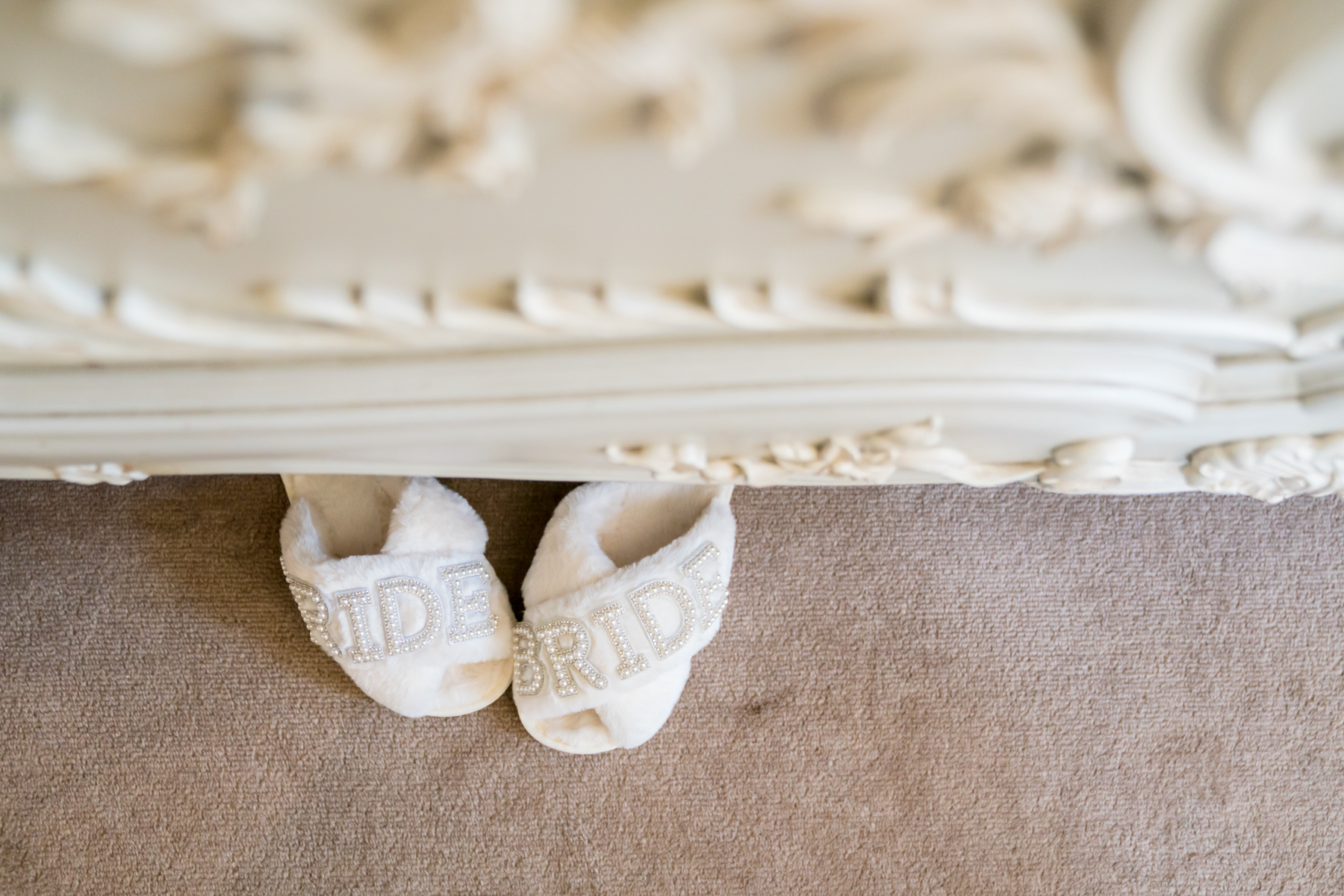 White bride slippers on carpet
