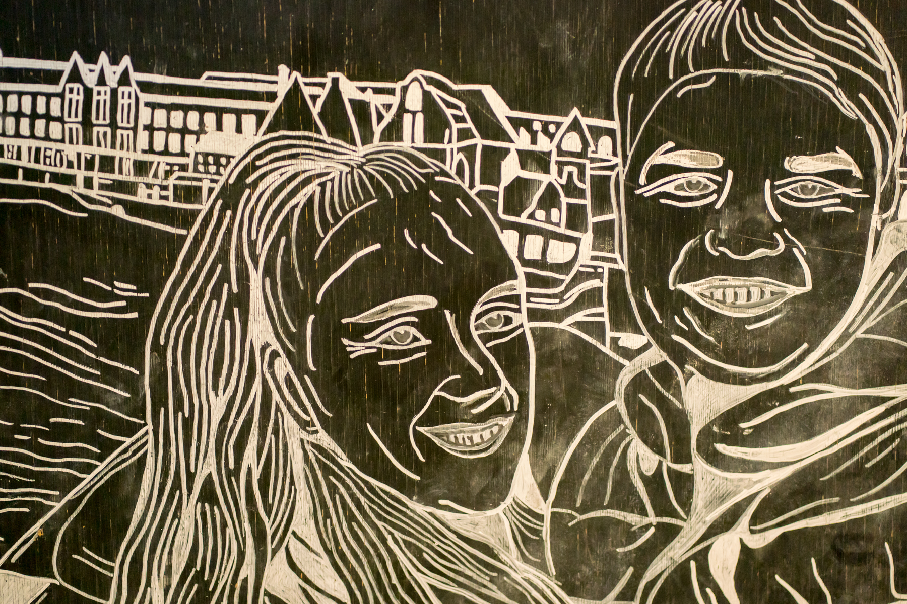 Intricate black and white wall carving artwork.