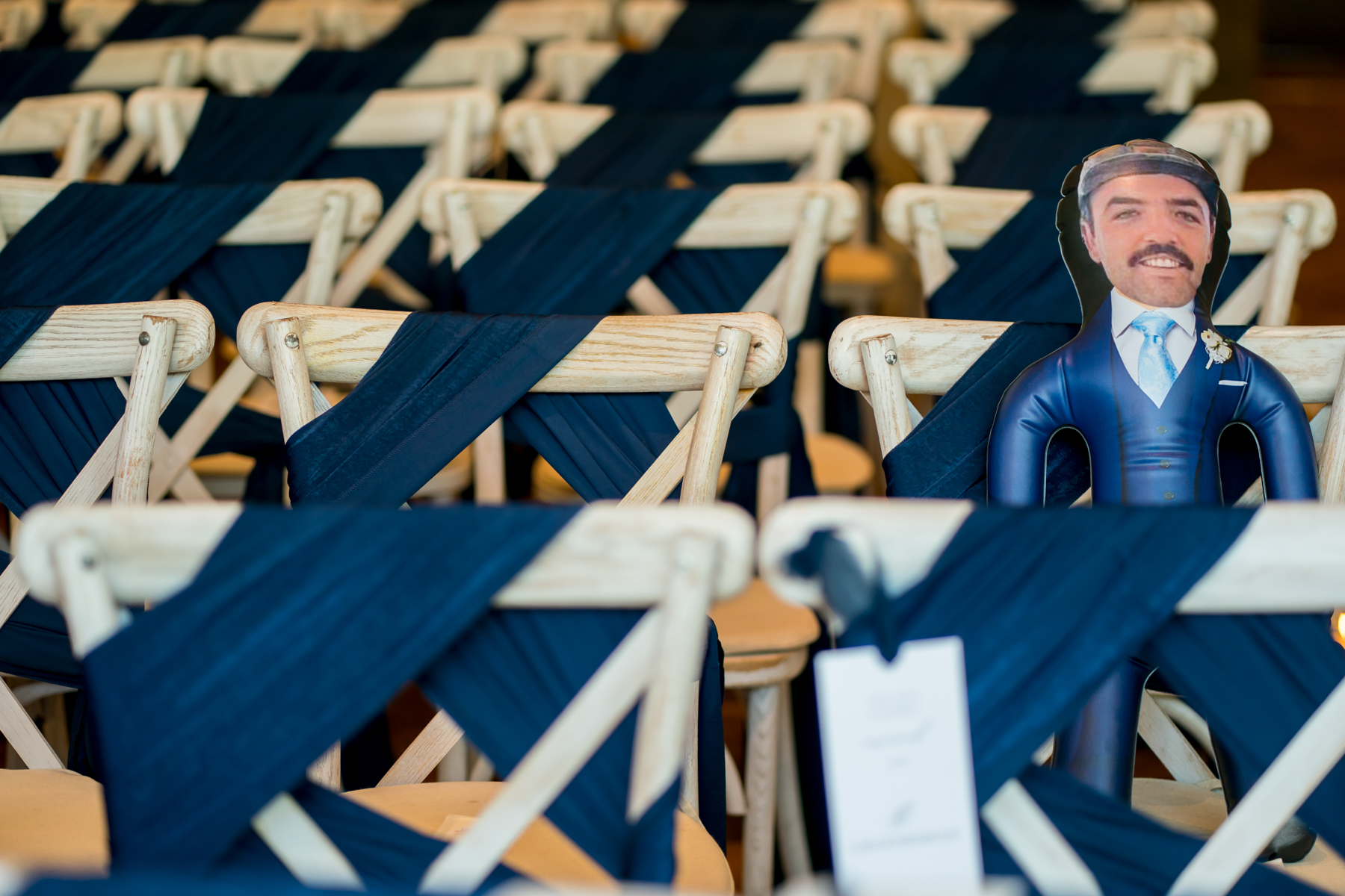 Decorated chairs with cardboard cutout at an event.