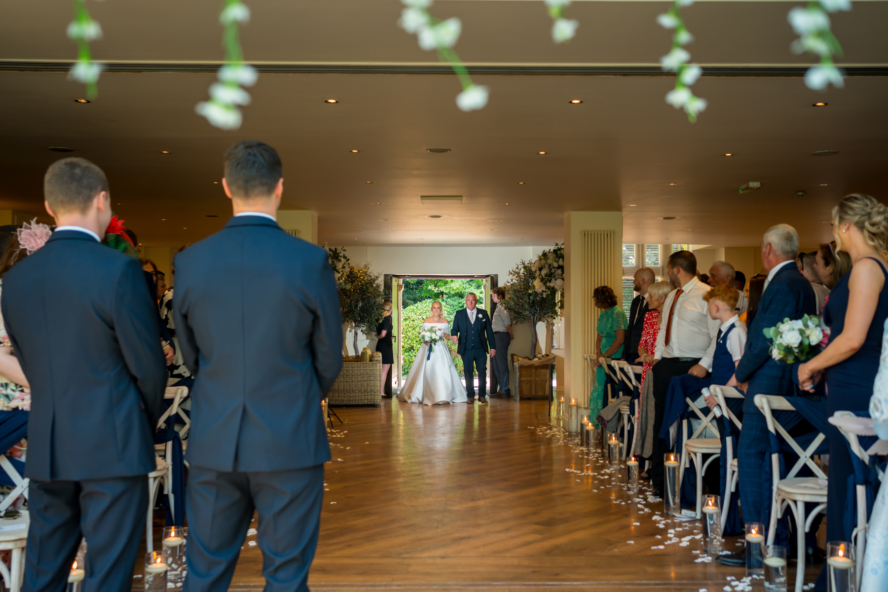 Bride walking down the aisle at wedding ceremony.