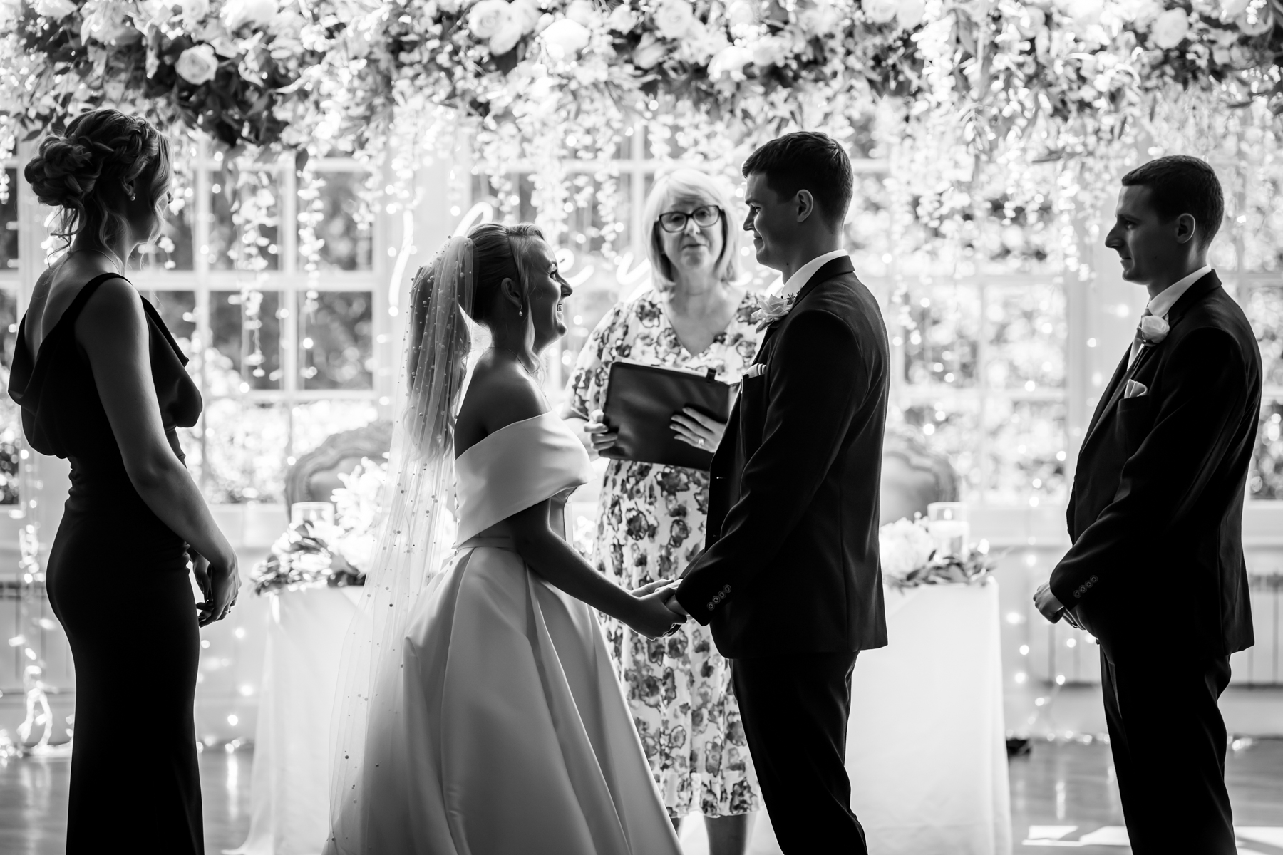 Bride and groom holding hands during wedding ceremony.