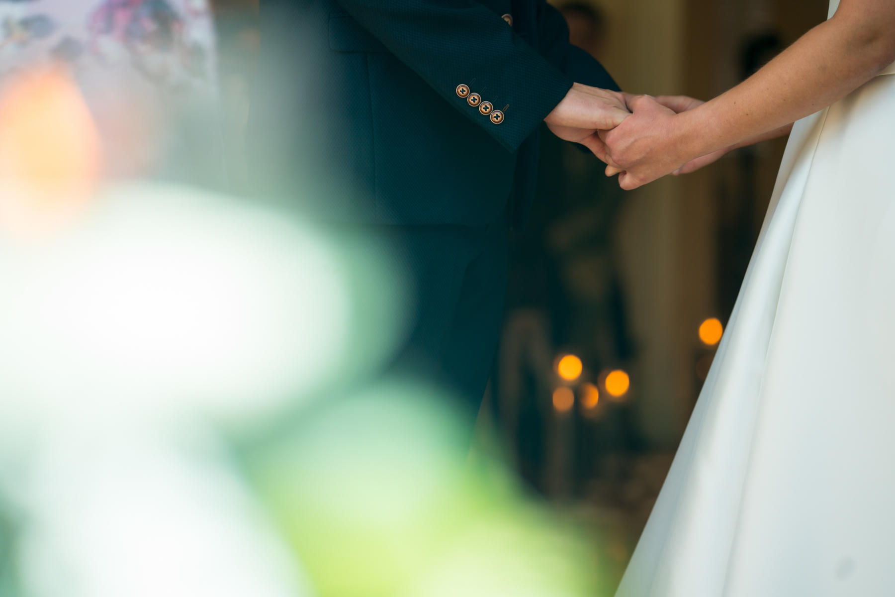 Couple holding hands at a wedding ceremony.