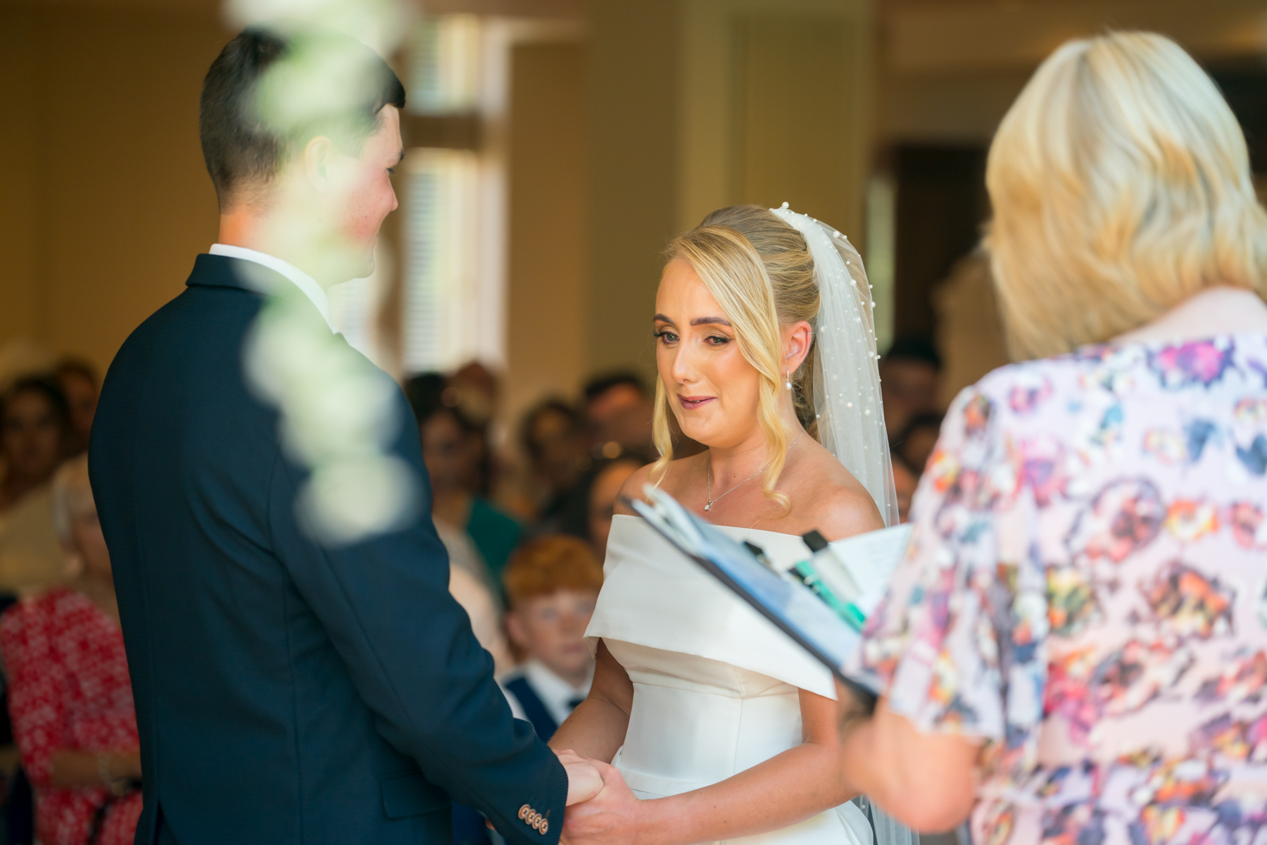 Bride and groom exchange vows at wedding ceremony.