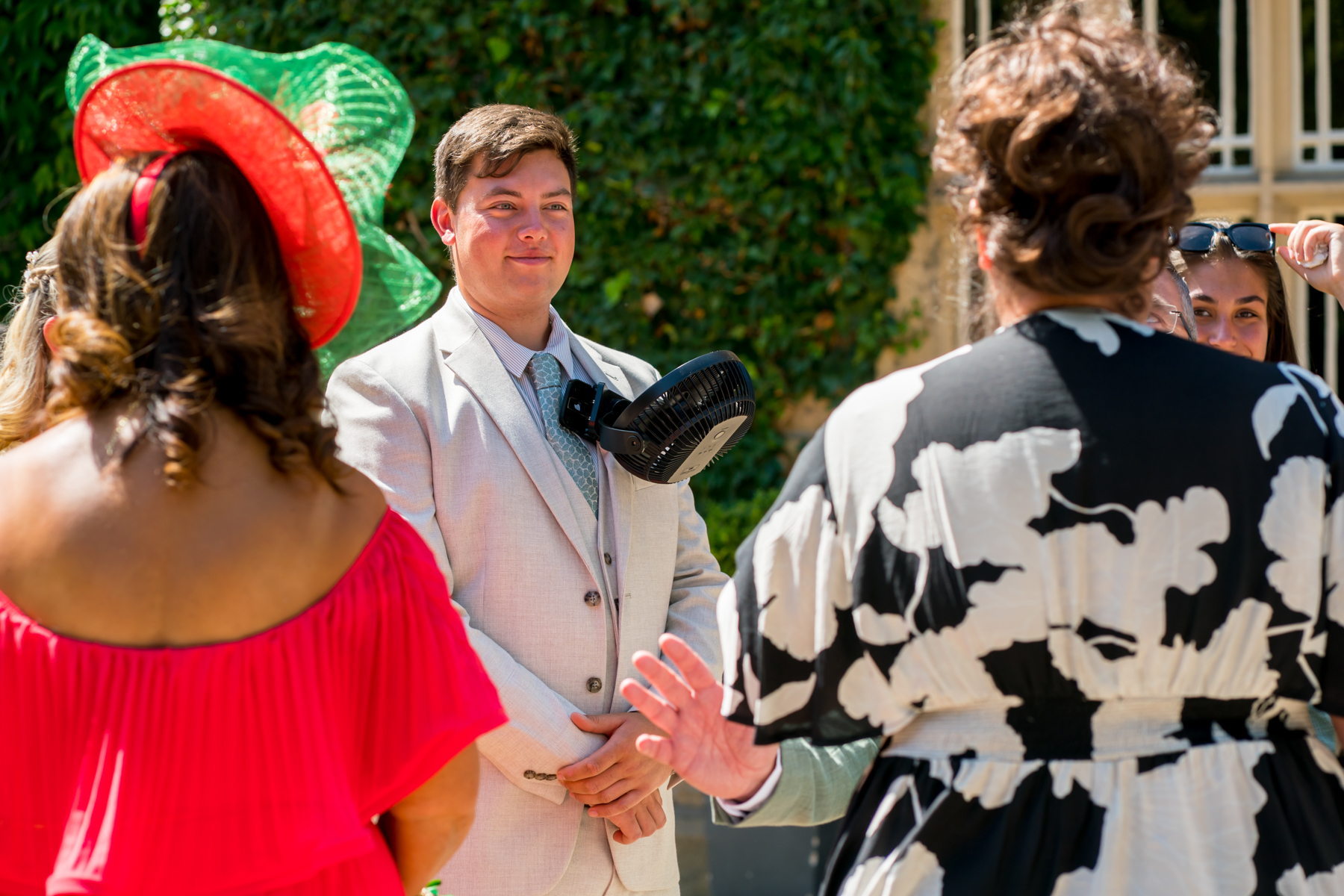 People at outdoor event with vibrant hats.
