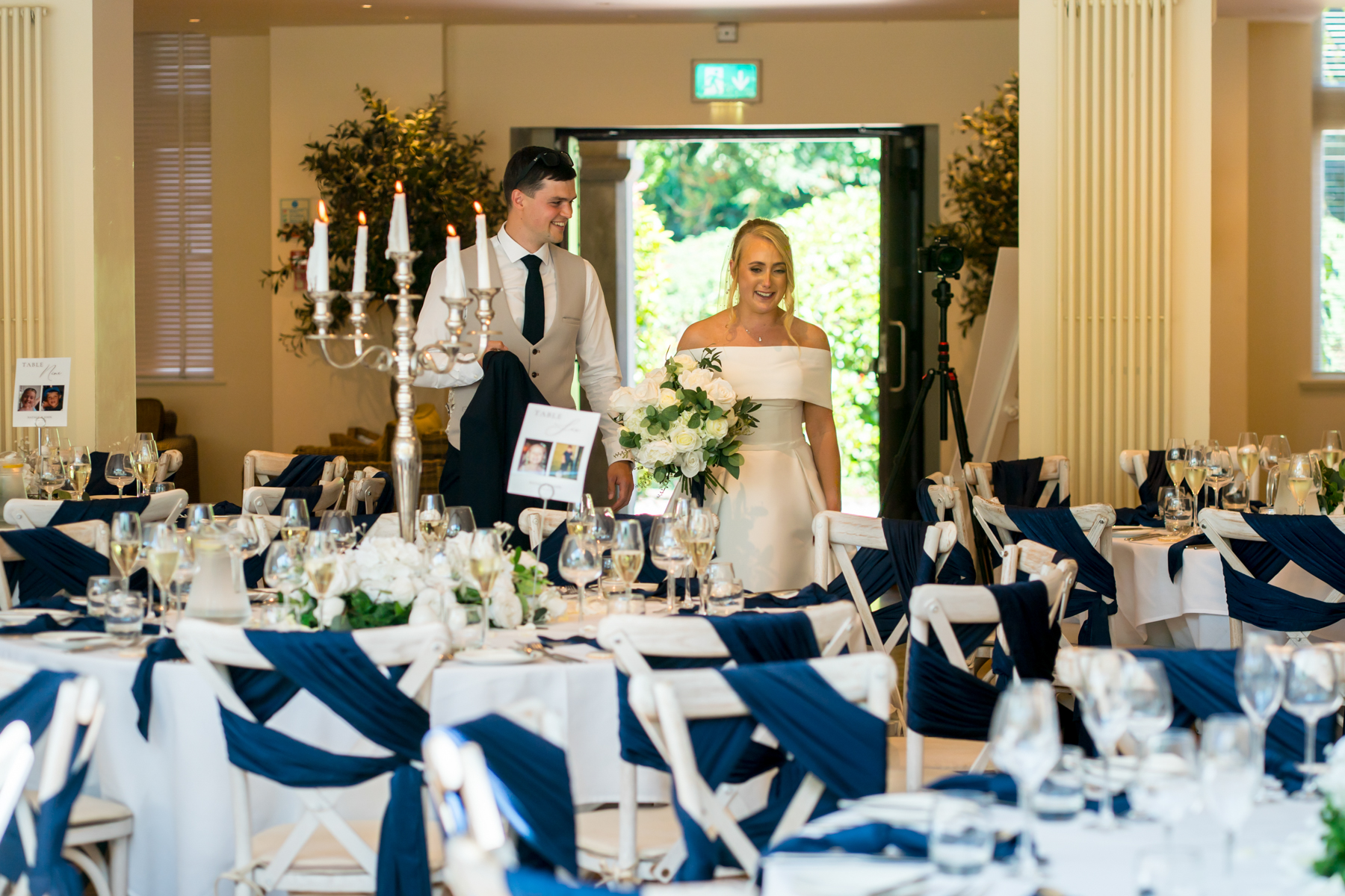Wedding couple entering elegant reception venue
