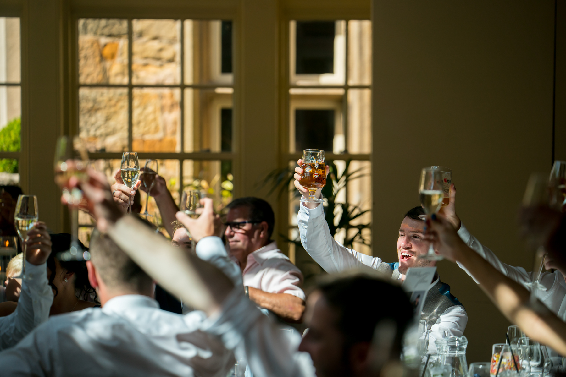People toasting with drinks at a celebration.