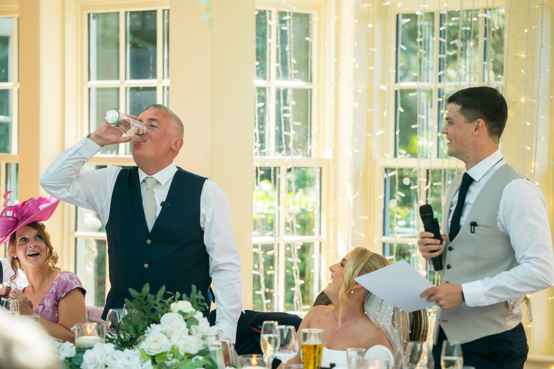 Man giving toast at wedding reception.