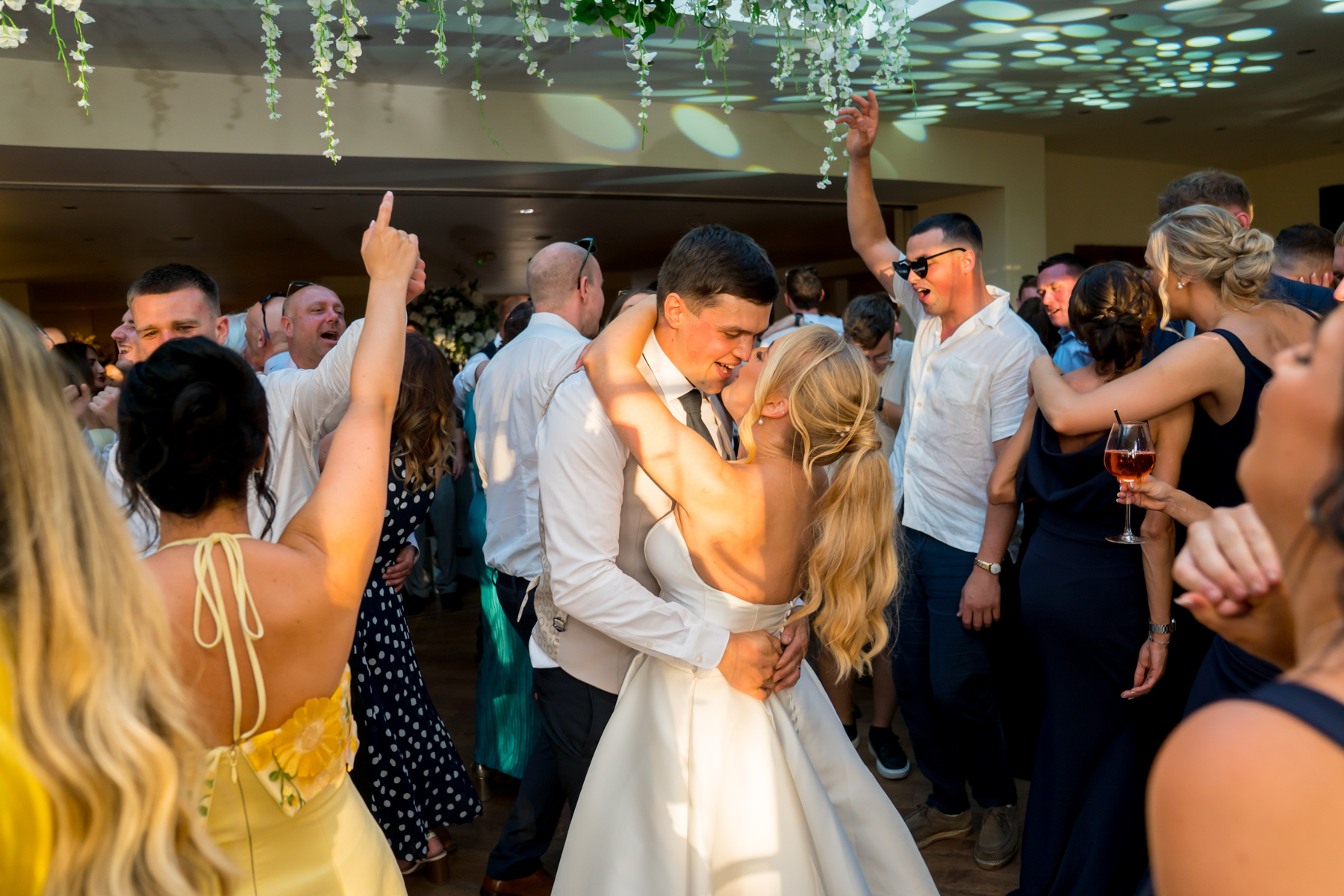 Couple dancing at a lively wedding reception.