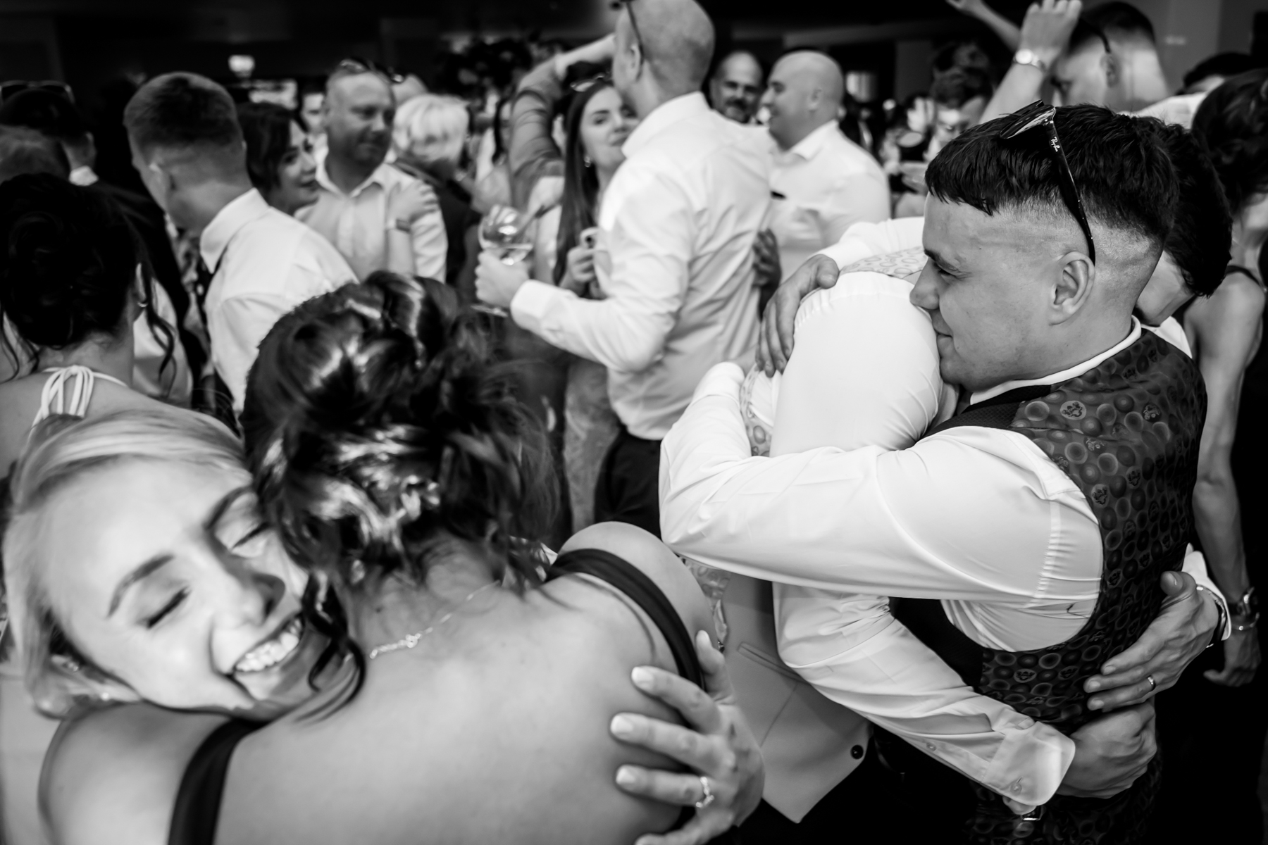 People hugging at a lively celebration event.